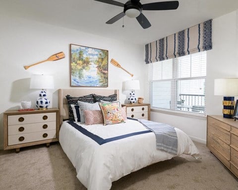 a bedroom with a bed and a ceiling fan